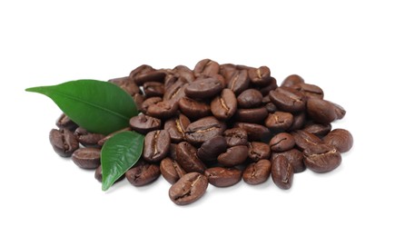 Photo of Pile of roasted coffee beans with fresh leaves on white background