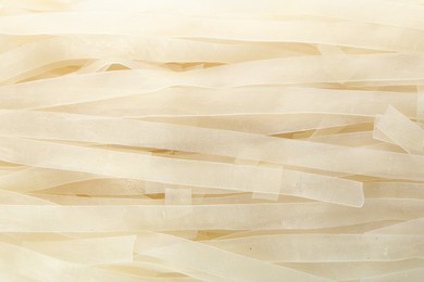 Photo of Raw rice noodles as background, closeup view