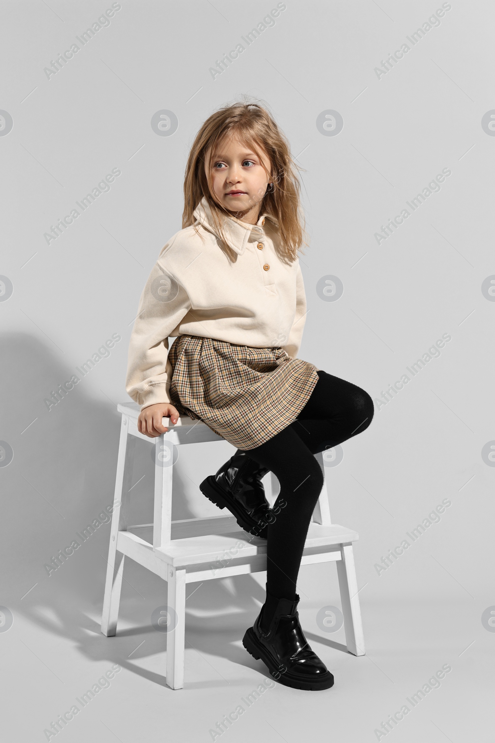 Photo of Fashion concept. Stylish girl posing on light grey background