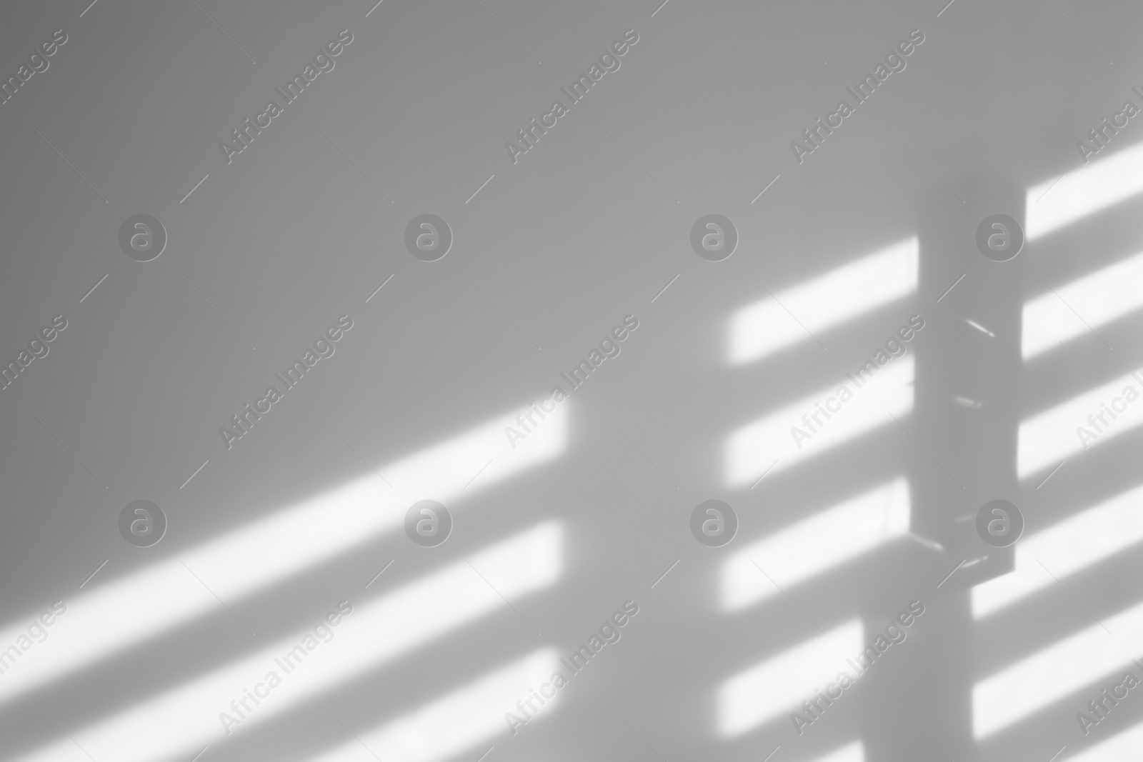 Photo of Lines made of light and shadows on white wall