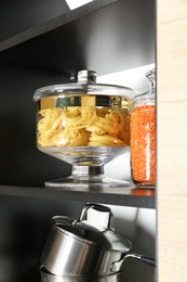 Products and kitchen utensils on modern shelving unit