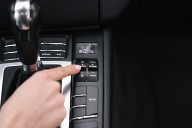 Woman using dashboard while driving her car, closeup