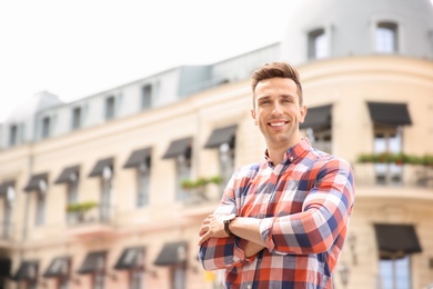 Portrait of attractive young man in stylish outfit outdoors