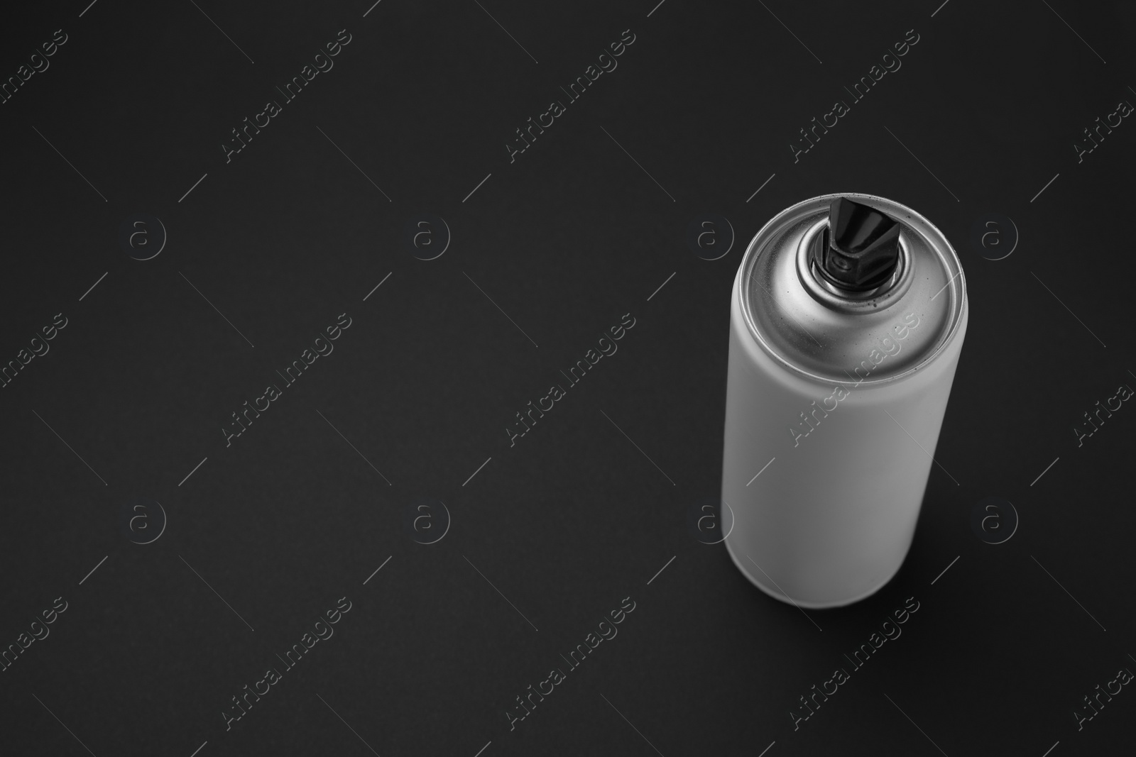 Photo of Can of graffiti spray paint on black background, above view. Space for text