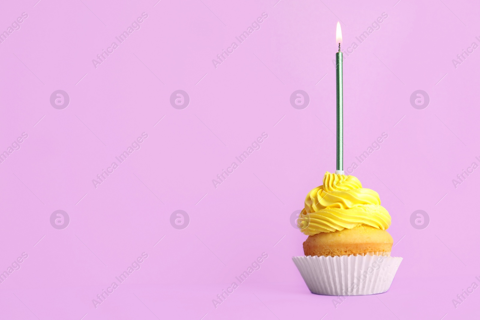 Photo of Birthday cupcake with candle on violet background, space for text