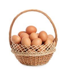 Chicken eggs in wicker basket isolated on white