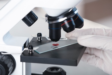 Photo of Analyst doing laboratory test with microscope, closeup. Chemical analysis