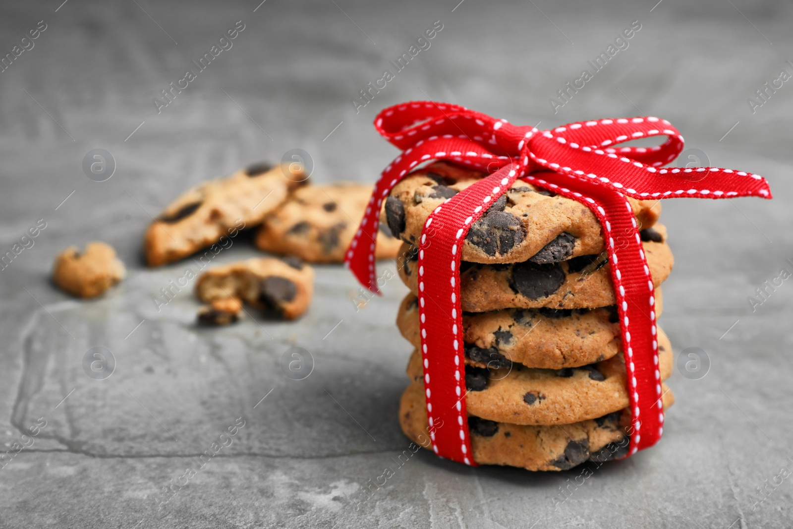 Photo of Stack of cookies with chocolate chips on grey background