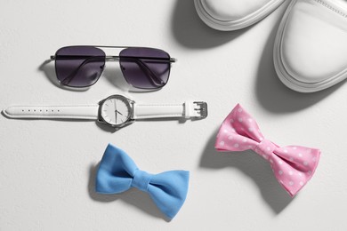 Photo of Stylish color bow ties, shoes and accessories on white background, flat lay