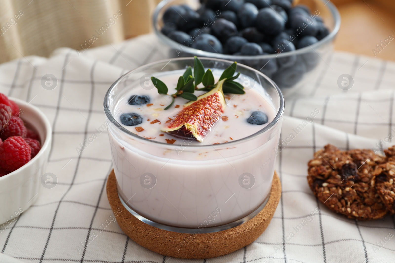 Photo of Delicious fig smoothie and berries on tray