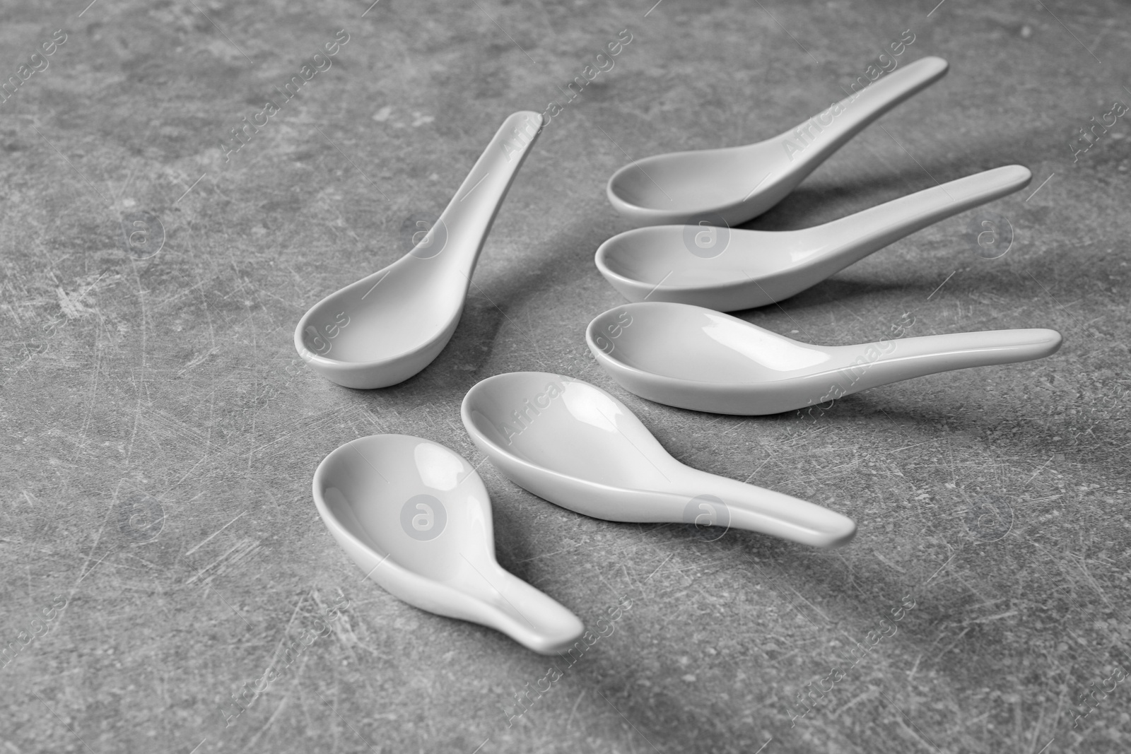 Photo of Clean Miso soup spoons on grey background