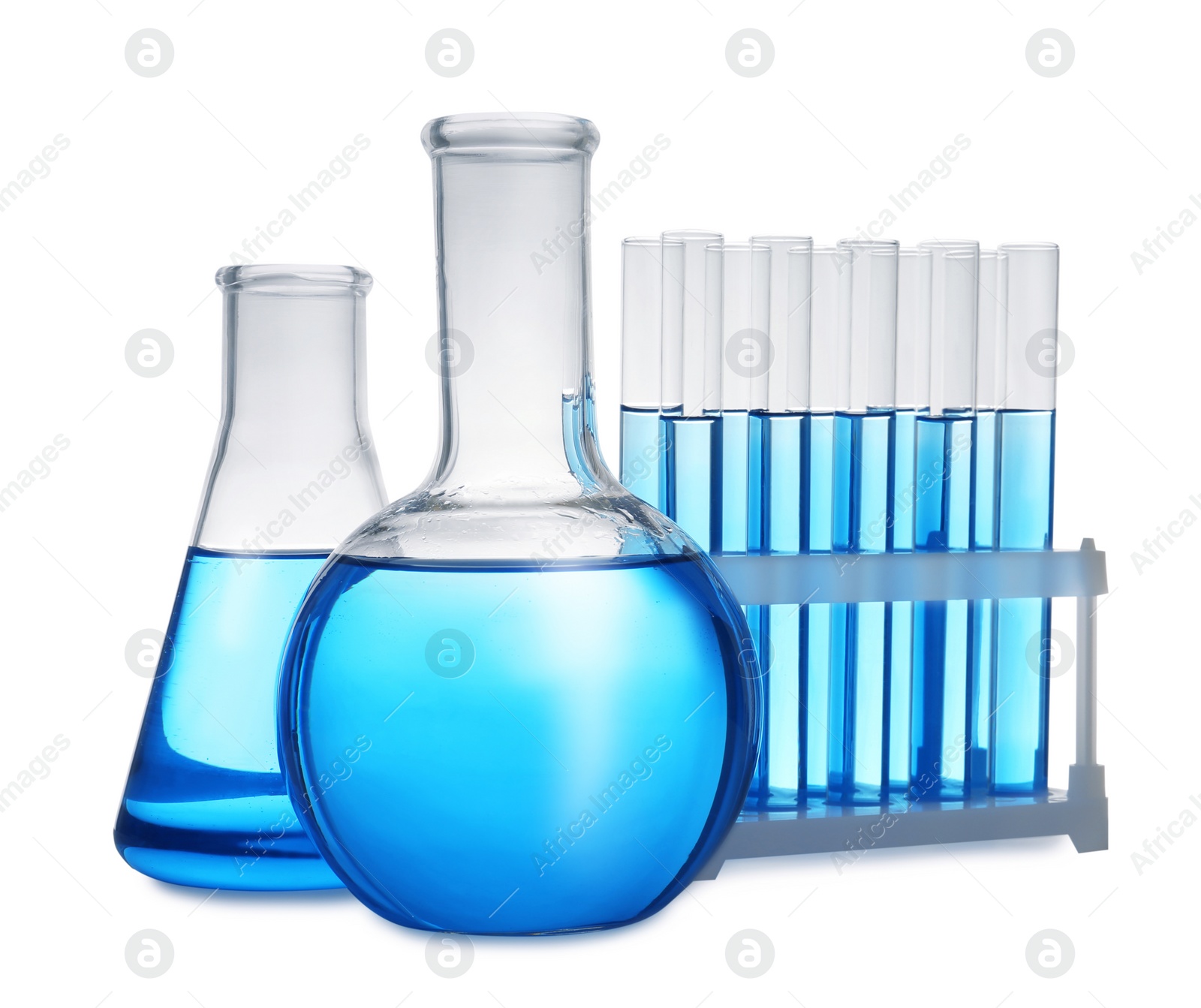 Photo of Set of laboratory glassware with blue liquid on white background