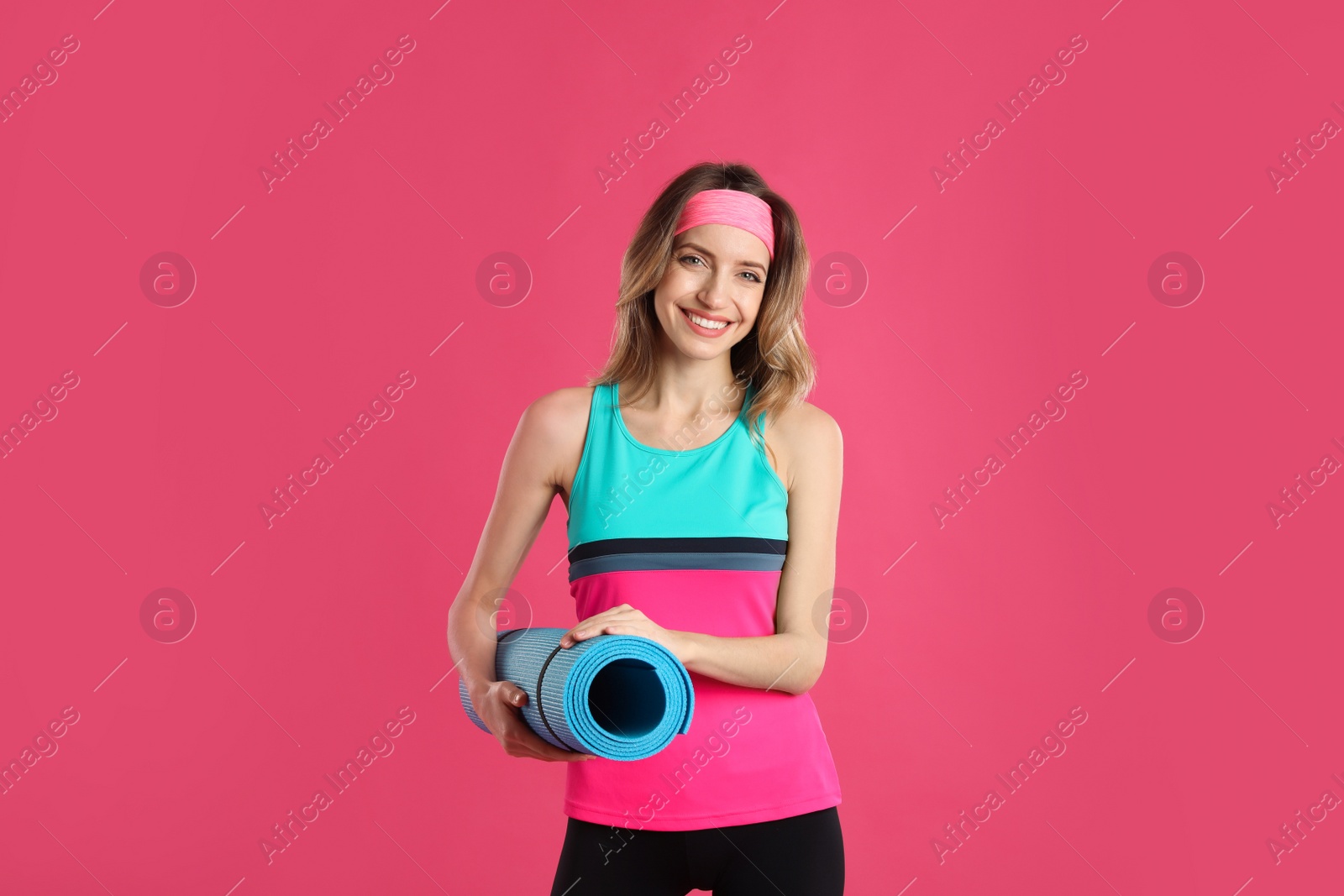 Photo of Beautiful woman with yoga mat on pink background