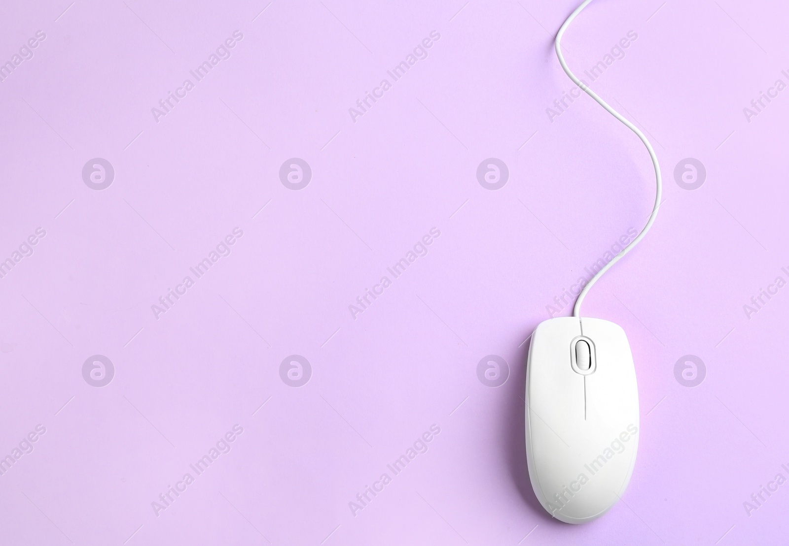 Photo of Modern wired optical mouse on lilac background, top view. Space for text