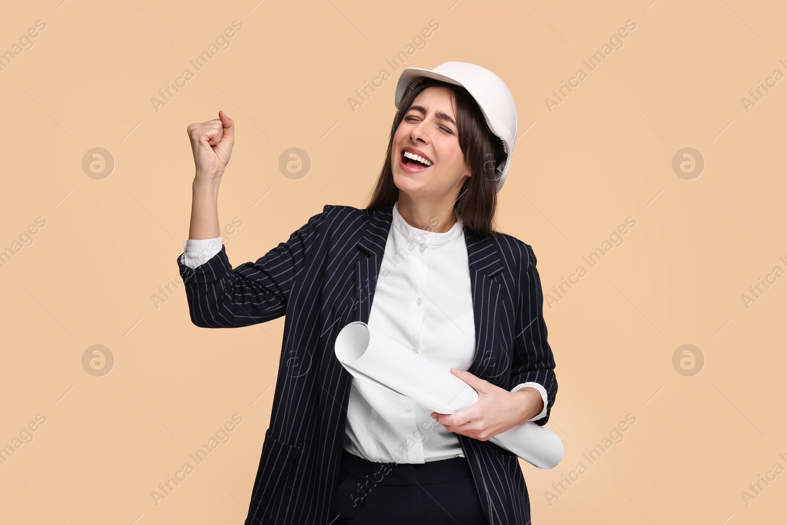 Photo of Architect in hard hat with draft on beige background