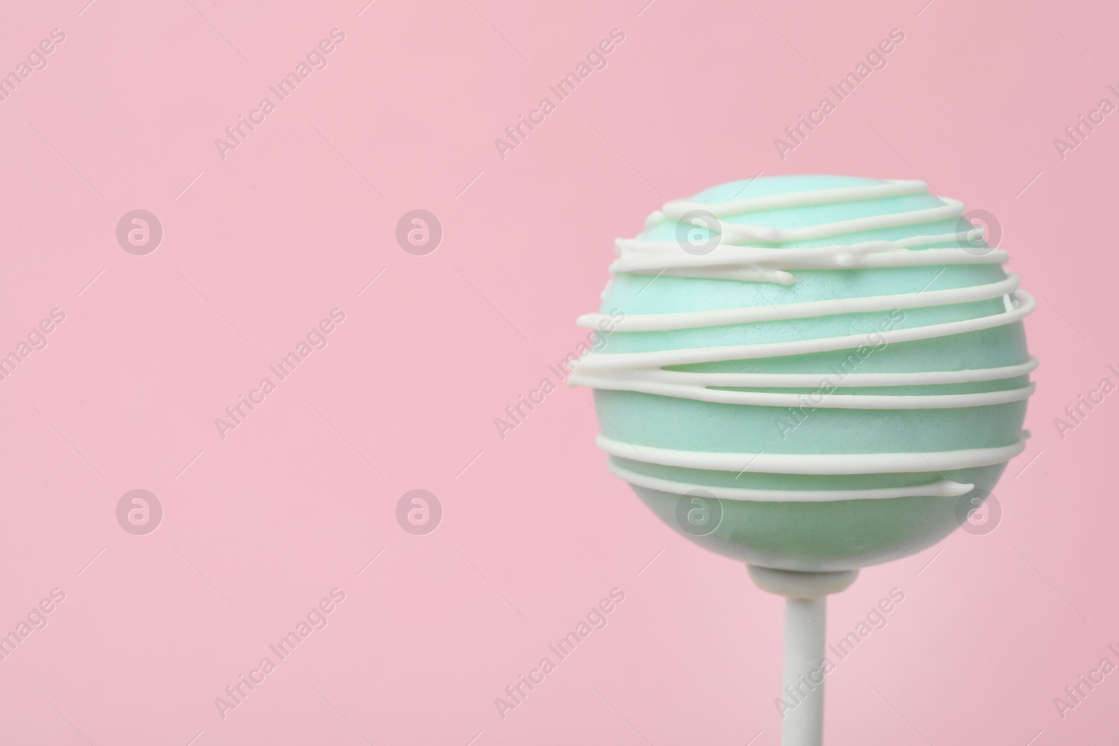 Photo of Sweet decorated cake pop on pink background, space for text