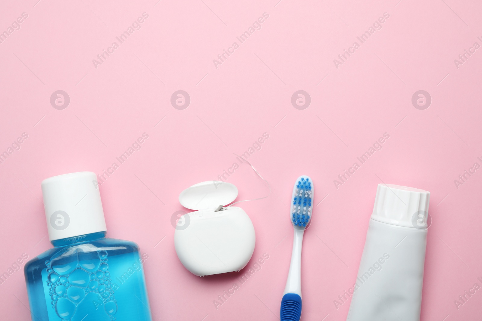 Photo of Flat lay composition with toothpaste, oral hygiene products and space for text on color background