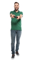 Emotional young man playing video games with controller isolated on white