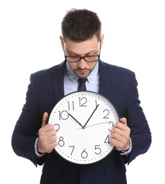 Photo of Businessman holding clock on white background. Time management