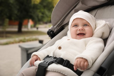 Photo of Portrait of adorable baby in stroller outdoors