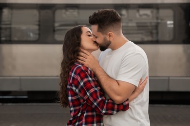Photo of Long-distance relationship. Beautiful couple kissing on platform of railway station