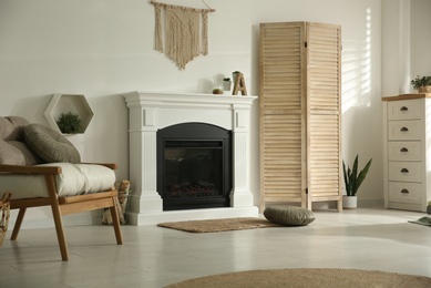 Bright living room interior with fireplace and basket of firewood