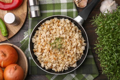 Photo of Fried ground meat in frying pan and products on wooden table, flat lay