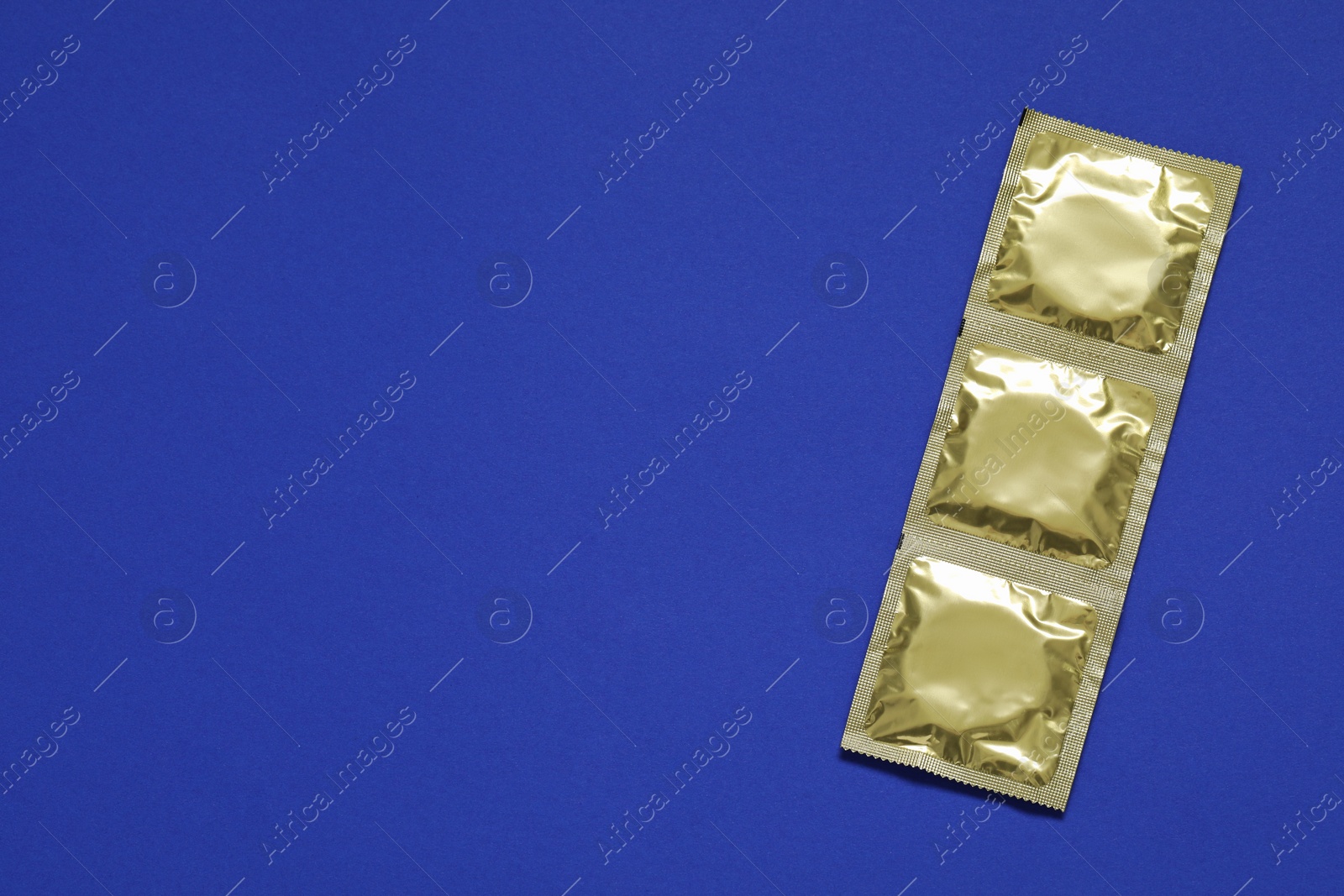 Photo of Condom packages on light blue background, top view and space for text. Safe sex