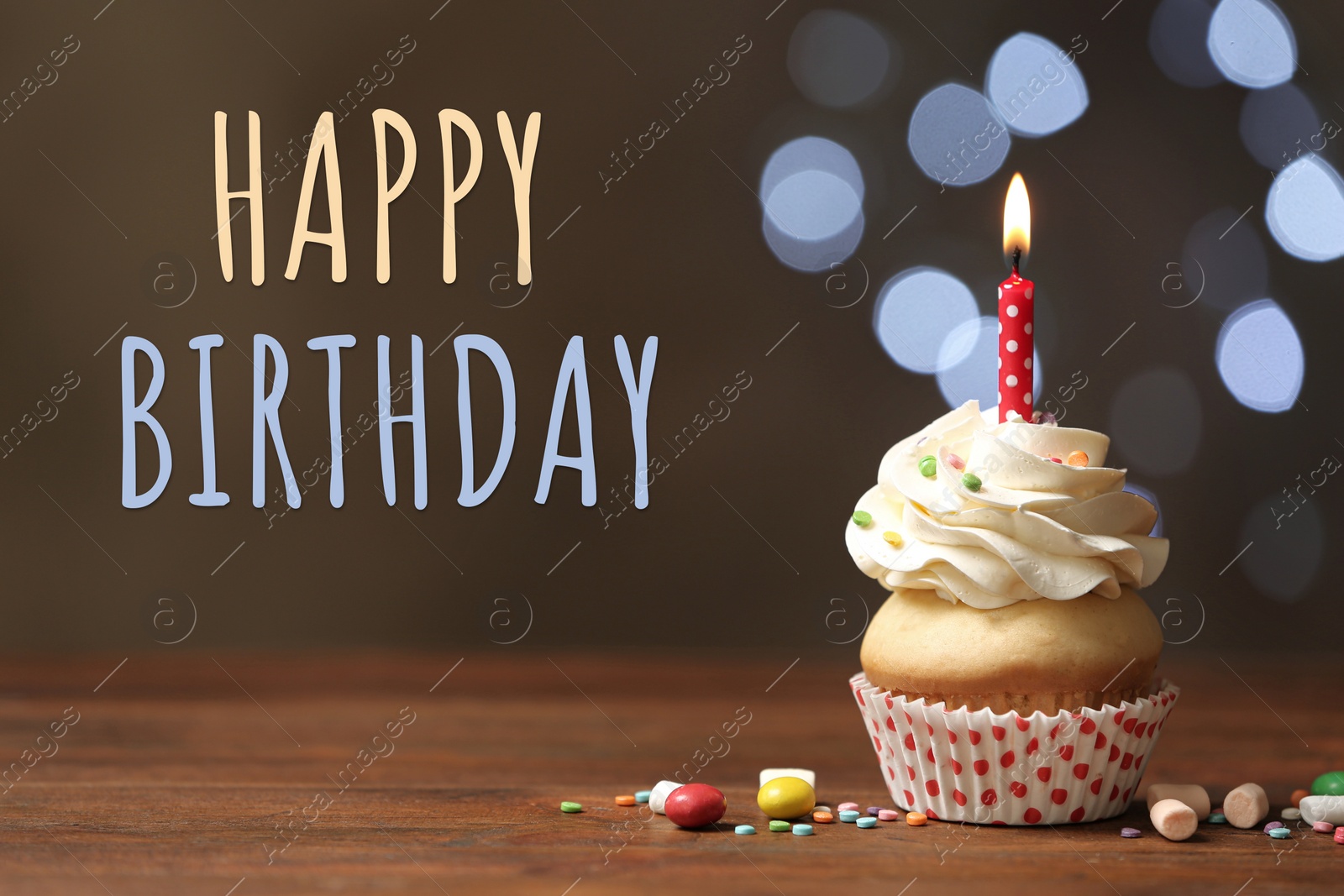 Image of Happy Birthday! Delicious cupcake with candle on wooden table