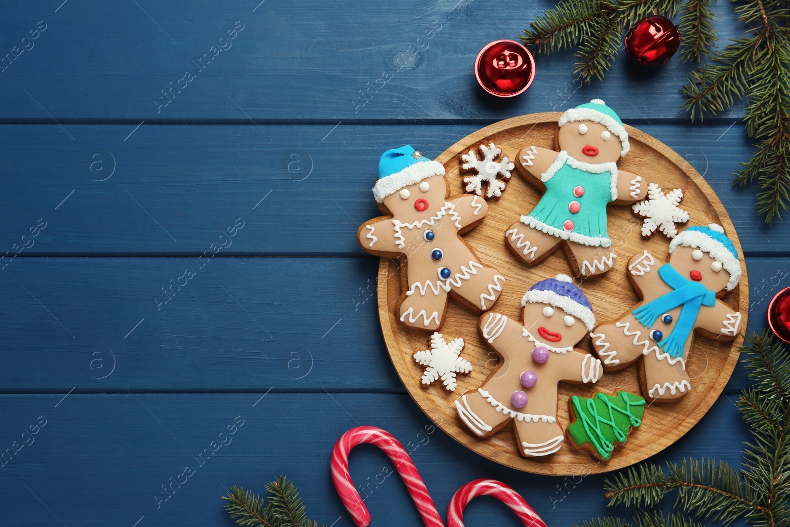 Photo of Flat lay composition with delicious Christmas cookies on blue wooden table, space for text