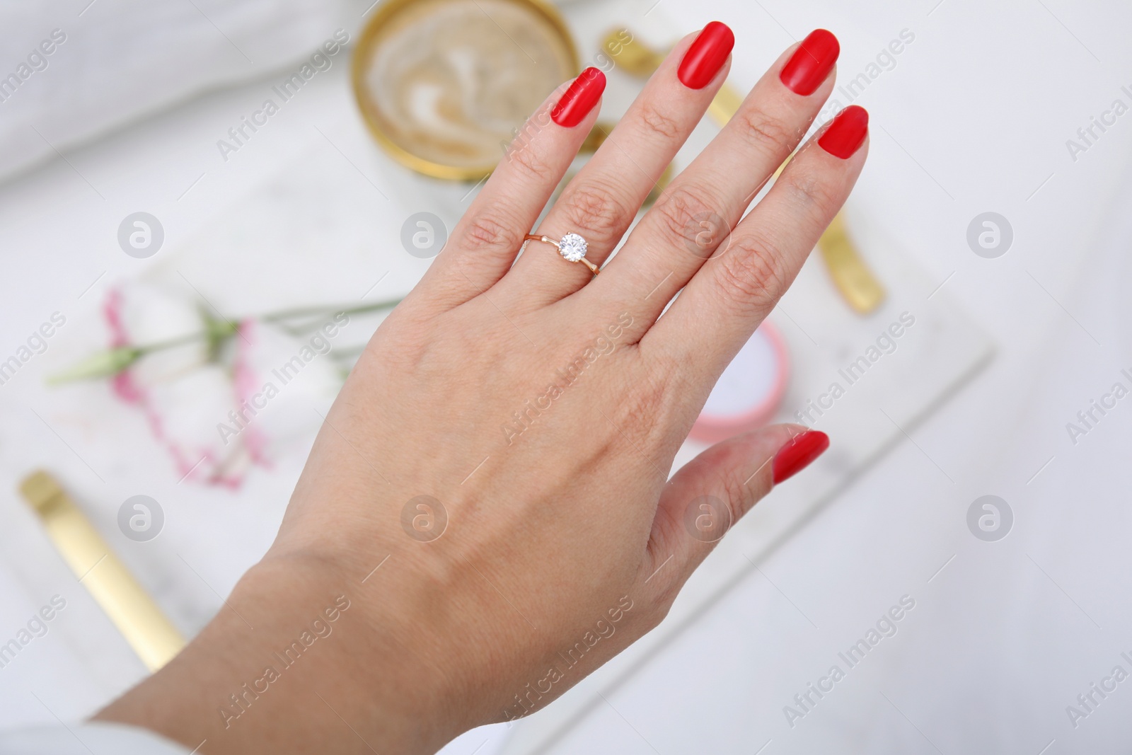 Photo of Young woman wearing beautiful engagement ring, closeup