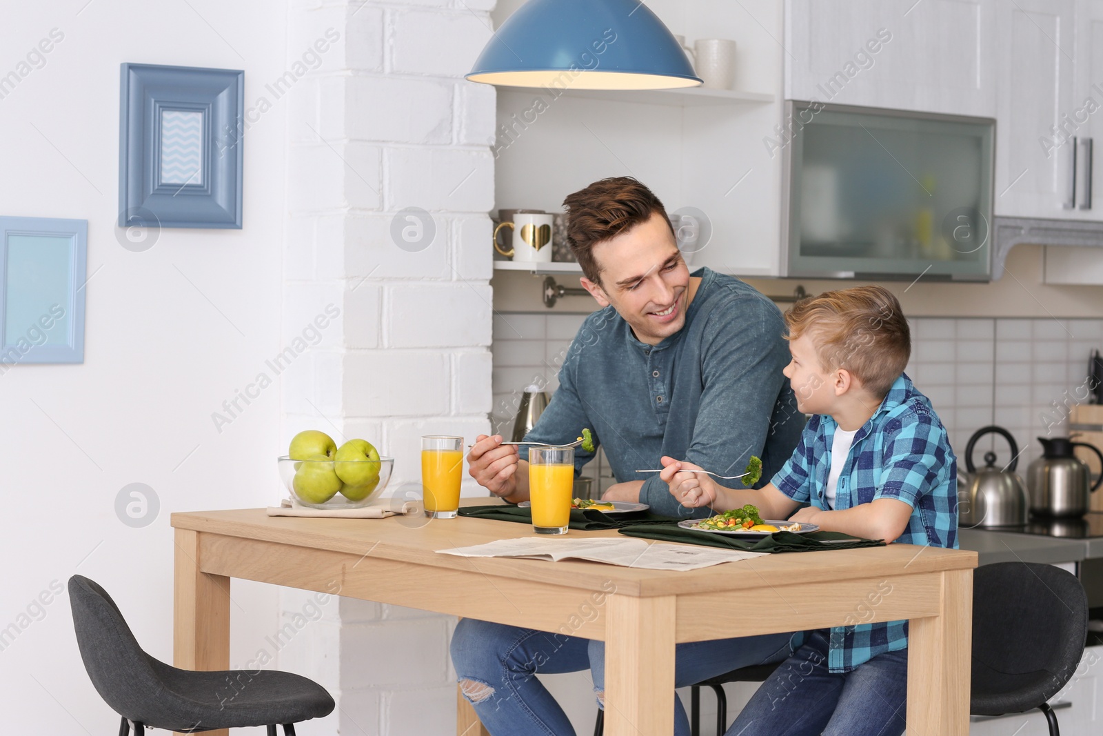 Photo of Dad and his son having breakfast in kitchen