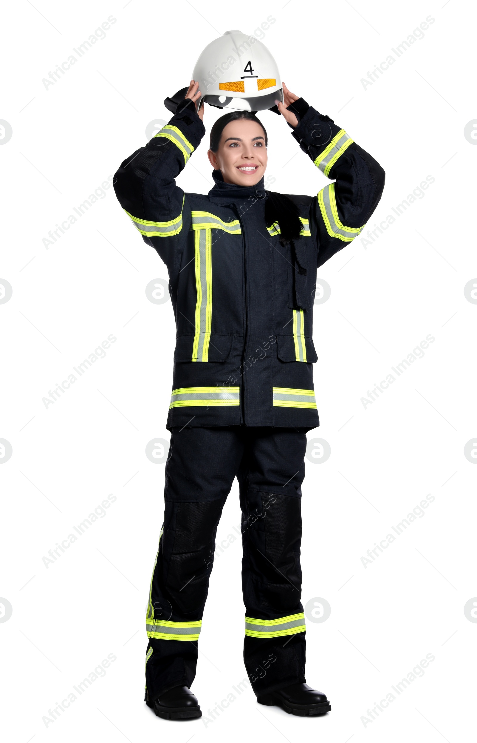 Photo of Full length portrait of firefighter in uniform wearing helmet on white background