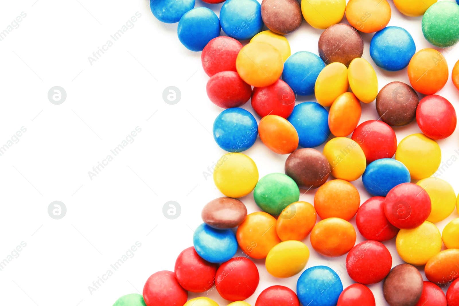 Photo of Tasty colorful candies on white background, top view