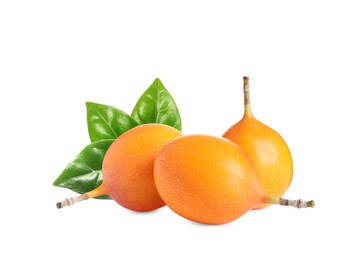 Tasty ripe granadillas and green leaves on white background