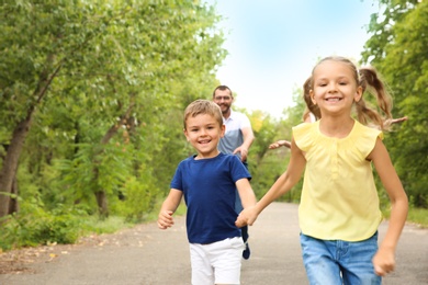 Happy family spending time together with their children outdoors