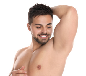 Photo of Young man showing hairless armpit after epilation procedure on white background