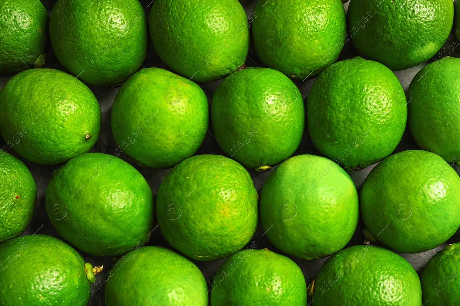 Photo of Fresh ripe green limes as background