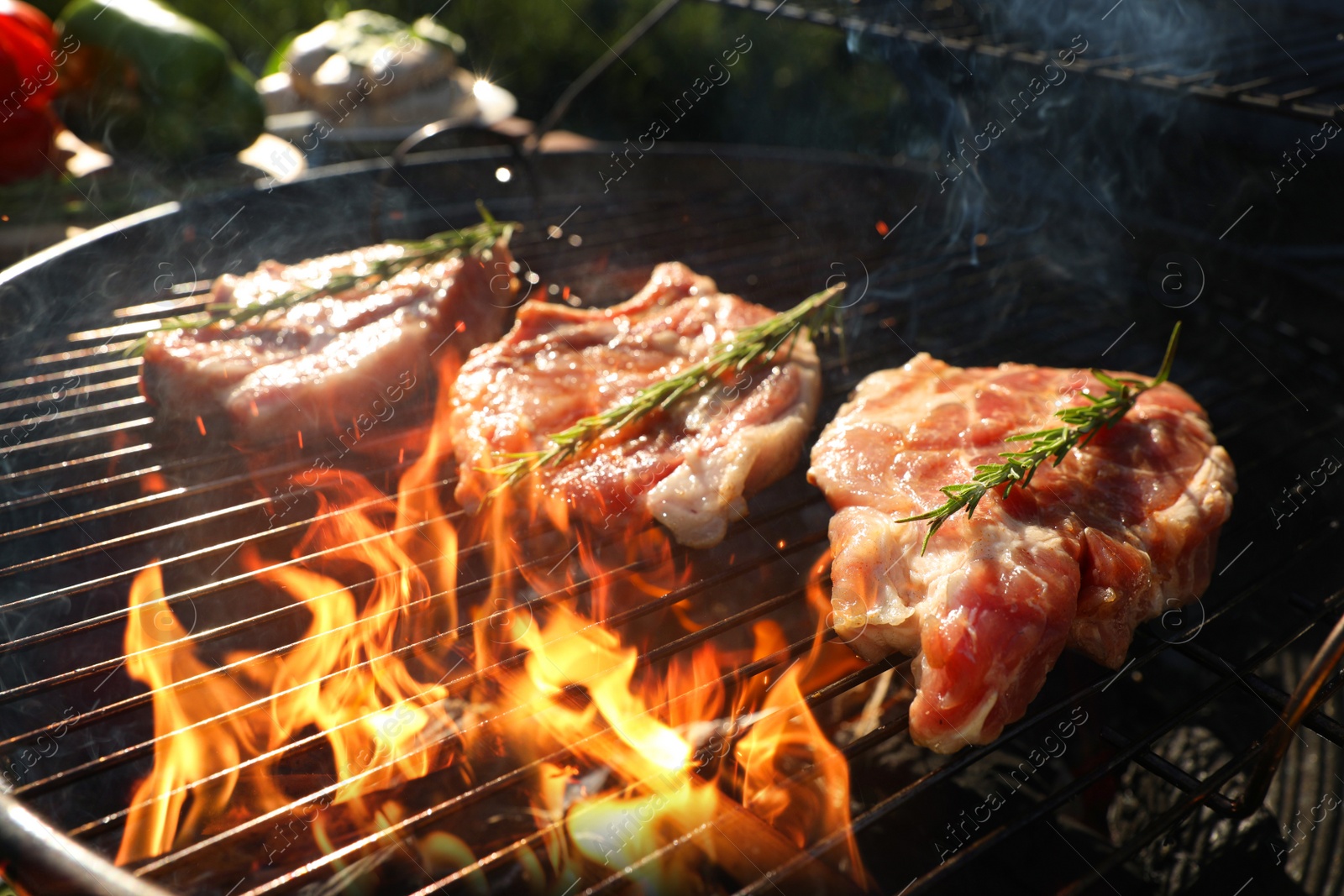 Photo of Cooking meat on barbecue grill outdoors, closeup