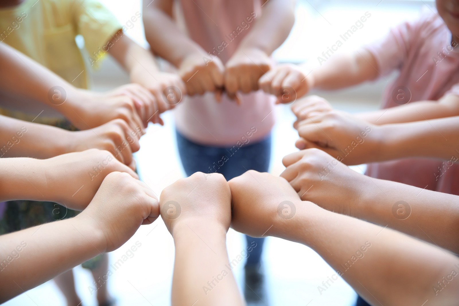 Photo of Little children putting their hands together, closeup. Unity concept