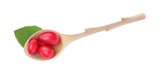 Fresh ripe dogwood berries in wooden spoon and green leaf on white background, top view