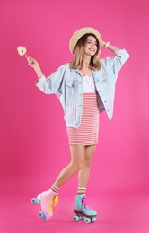 Young woman with lollipop and retro roller skates on color background