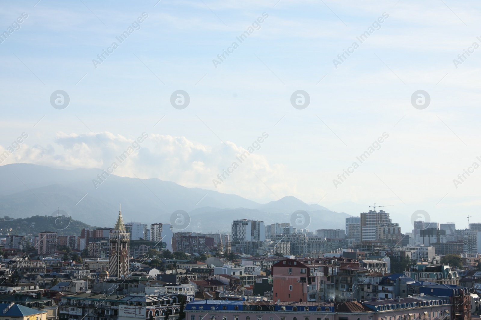 Photo of Picturesque view of modern city near mountains