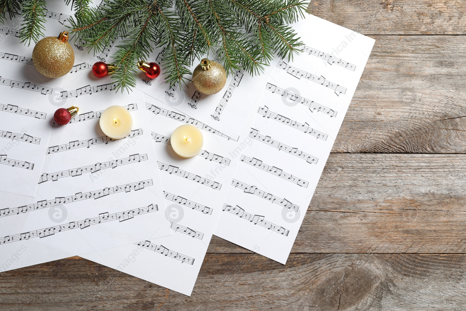 Photo of Flat lay composition with Christmas decorations and music sheets on wooden background