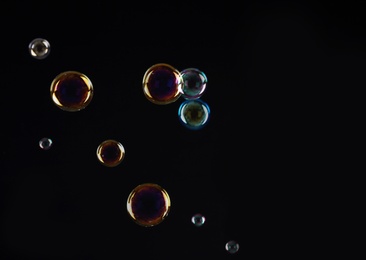 Beautiful translucent soap bubbles on dark background