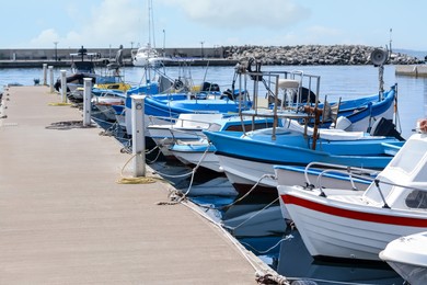 Photo of Beautiful view of city pier with moored boats on sunny day