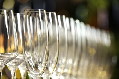 Photo of Set of empty glasses on blurred background, closeup