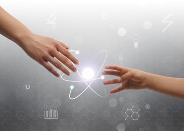 Image of Closeup view of people and virtual model of atom on light grey background