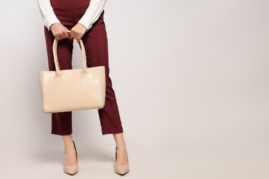 Photo of Young woman with stylish bag on white background, closeup