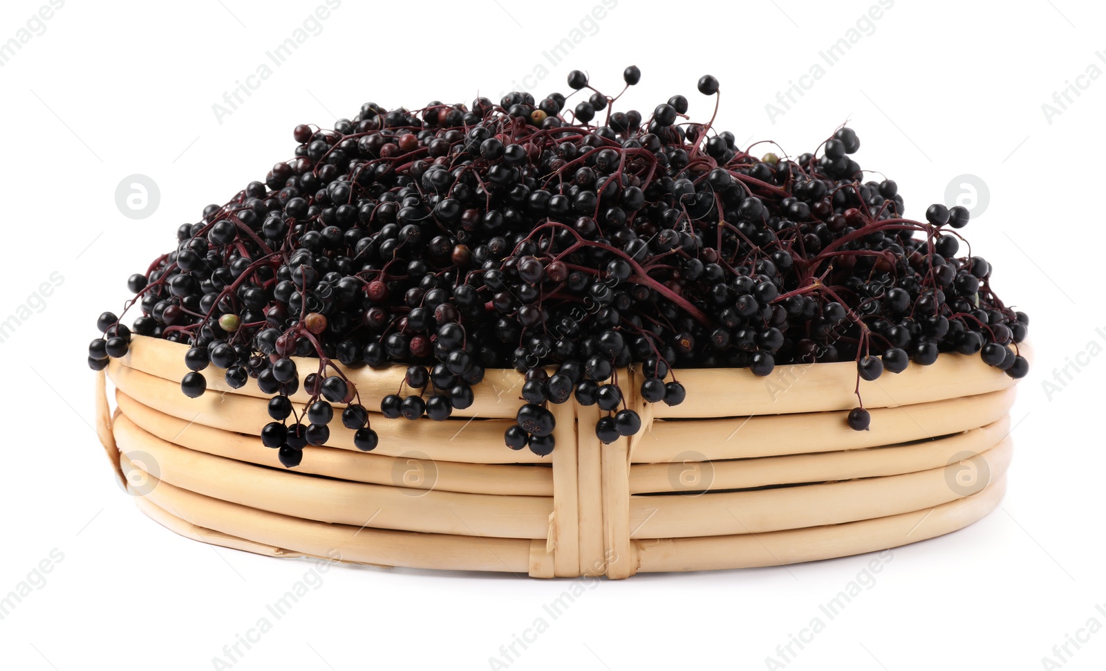 Photo of Wicker basket with ripe elderberries isolated on white